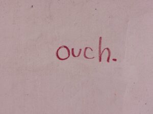 A close up of the word ouch written in red ink.